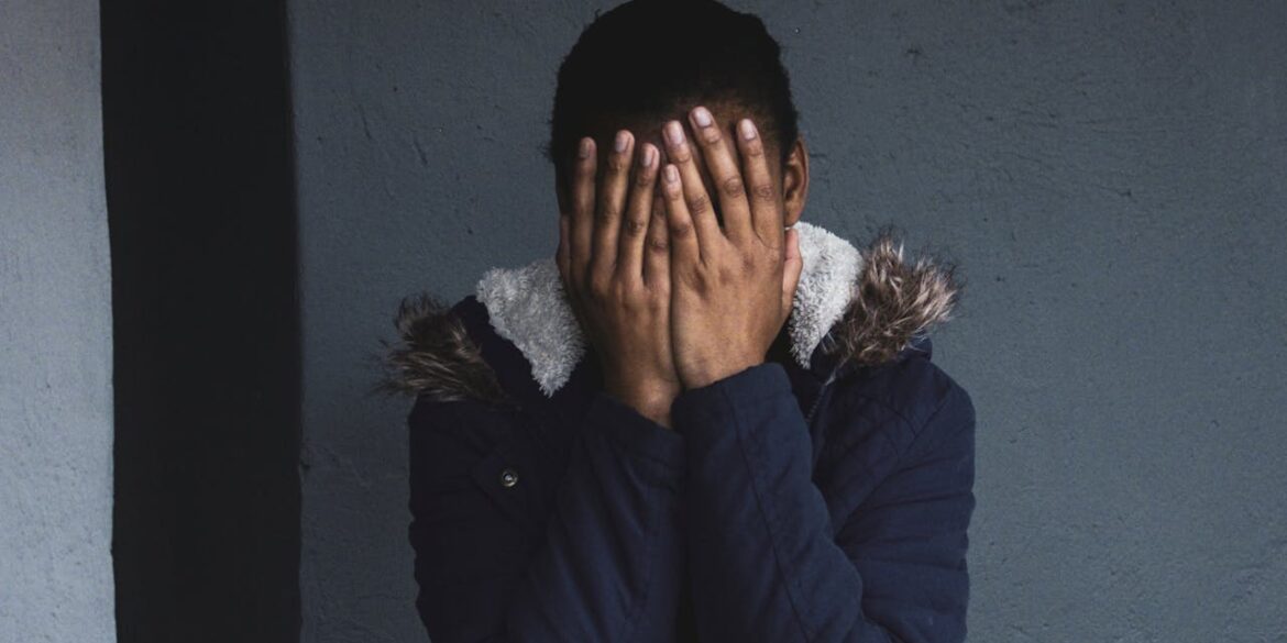 Photo by Justin Thompson: https://www.pexels.com/photo/a-person-wearing-blue-jacket-covering-face-with-her-hands-10369353/