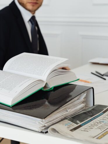 Photo by Photo By: Kaboompics.com: https://www.pexels.com/photo/book-and-binder-on-a-desk-7876088/