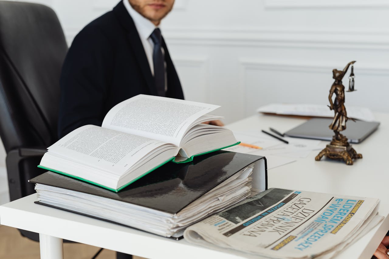 Photo by Photo By: Kaboompics.com: https://www.pexels.com/photo/book-and-binder-on-a-desk-7876088/