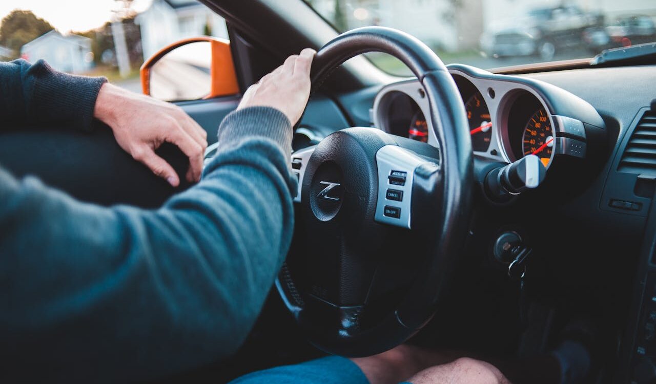 Photo by Erik Mclean: https://www.pexels.com/photo/man-driving-expensive-luxury-car-in-comfortable-interior-5158246/