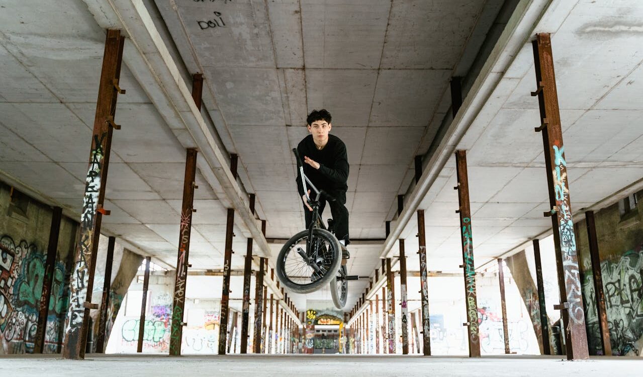 Photo by Tima Miroshnichenko: https://www.pexels.com/photo/a-man-doing-a-trick-with-his-bmx-bike-in-an-abandoned-building-7936432/