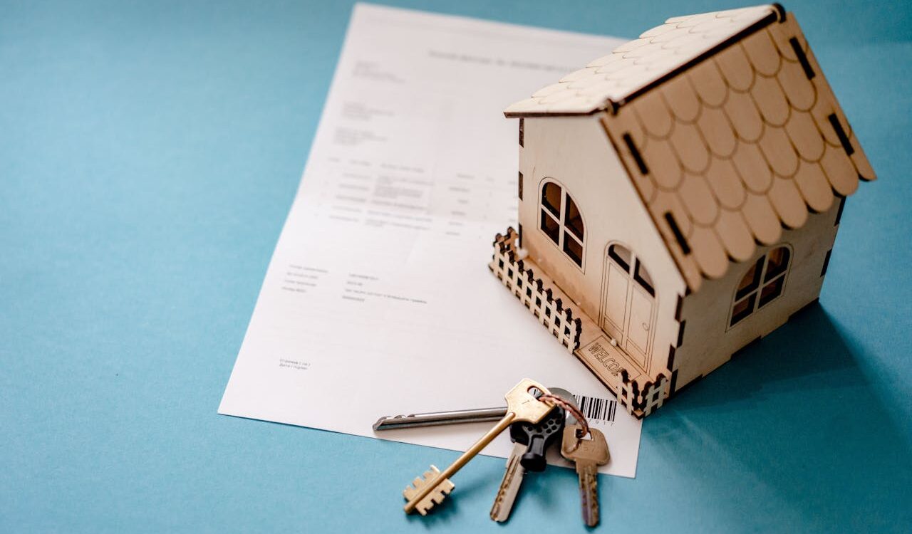Photo by Atlantic Ambience: https://www.pexels.com/photo/wooden-house-moder-keys-and-contract-on-table-12955837/