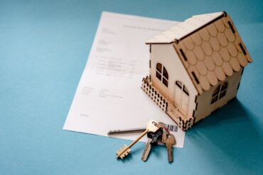 Photo by Atlantic Ambience: https://www.pexels.com/photo/wooden-house-moder-keys-and-contract-on-table-12955837/