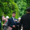 Photo by Chris F: https://www.pexels.com/photo/men-in-suit-and-uniforms-and-with-flags-in-ceremony-26225440/
