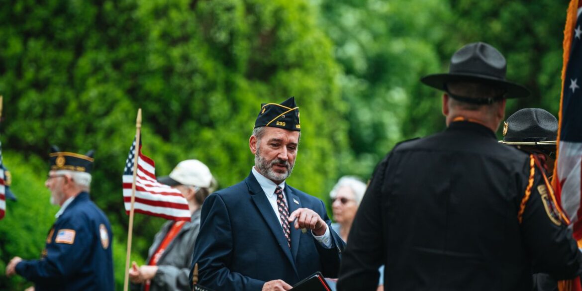 Photo by Chris F: https://www.pexels.com/photo/men-in-suit-and-uniforms-and-with-flags-in-ceremony-26225440/