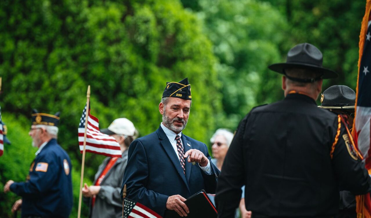 Photo by Chris F: https://www.pexels.com/photo/men-in-suit-and-uniforms-and-with-flags-in-ceremony-26225440/
