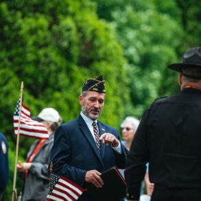 Photo by Chris F: https://www.pexels.com/photo/men-in-suit-and-uniforms-and-with-flags-in-ceremony-26225440/