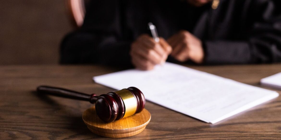 Photo by KATRIN BOLOVTSOVA: https://www.pexels.com/photo/judge-signing-on-the-papers-6077447/