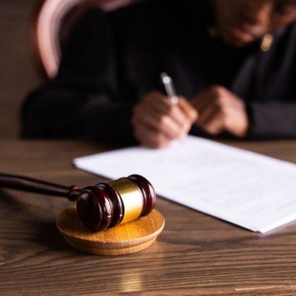 Photo by KATRIN BOLOVTSOVA: https://www.pexels.com/photo/judge-signing-on-the-papers-6077447/